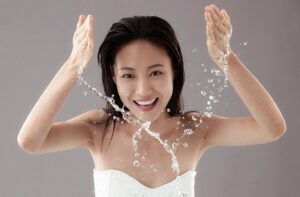 The young woman washing a face,