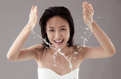 The young woman washing a face,